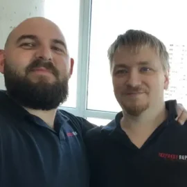 Two Express Repair appliance technicians smiling